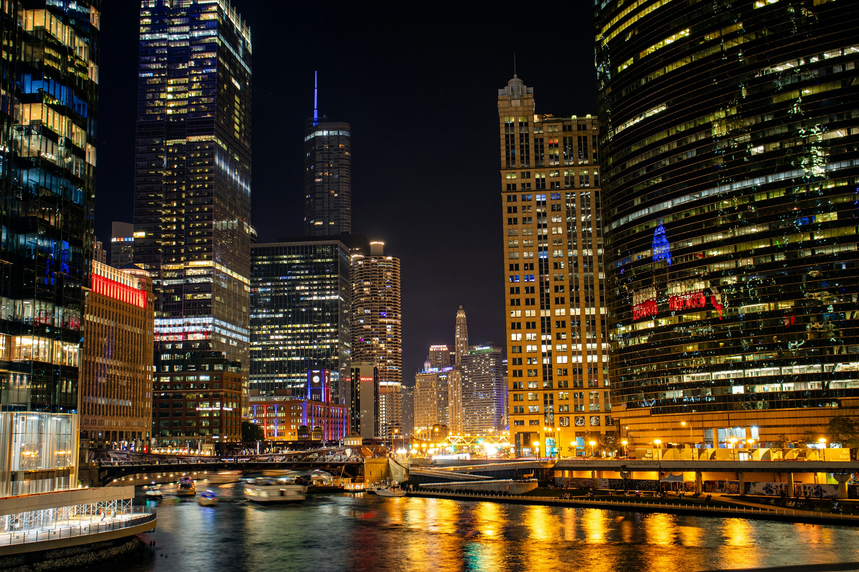 Illuminated commercial buildings along the Chicago River at night